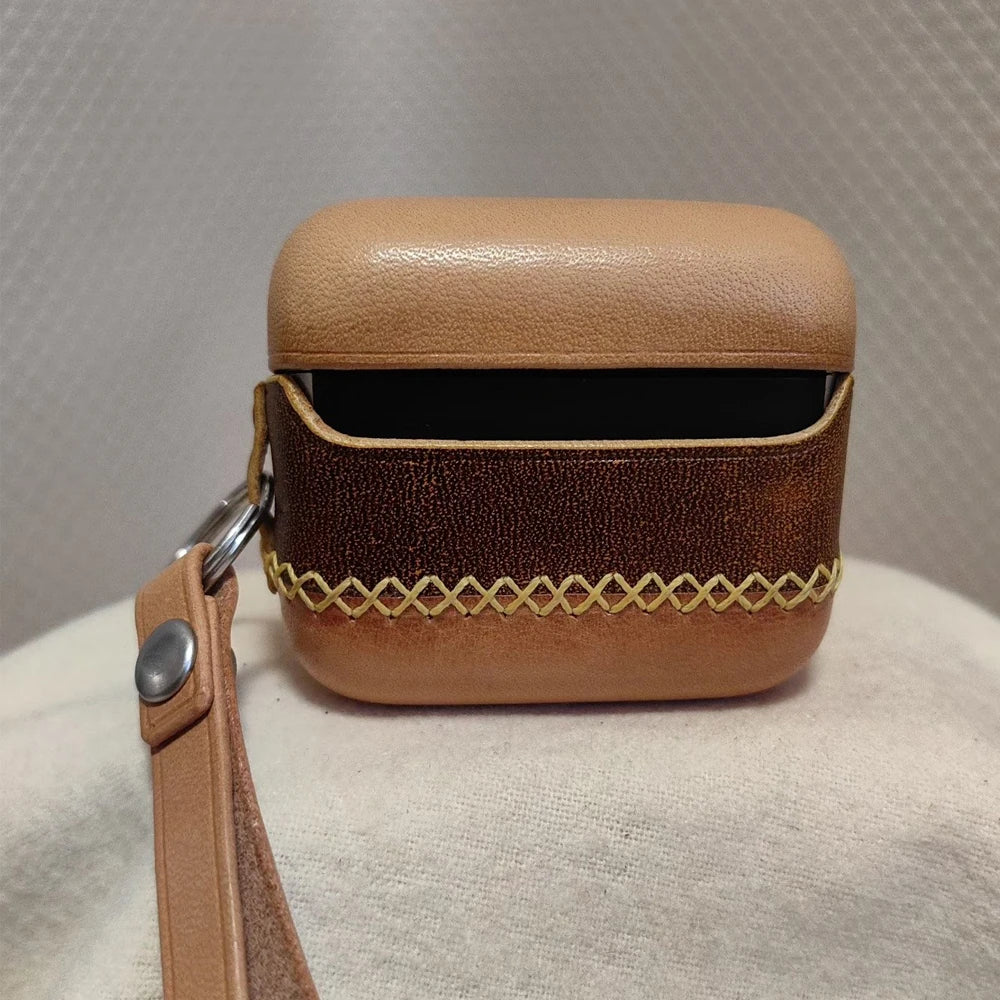 Detailed shot of the handcrafted full-grain leather earbuds case for Bang & Olufsen Beo Grace from the back, showing the ergonomic hinge design and attached portable strap.