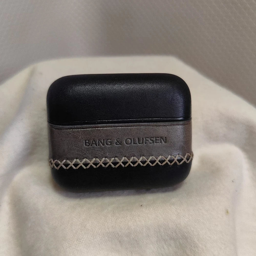 Front view of the Ronuo handmade Black and Dark Grey leather case for Bang & Olufsen Beo Grace, featuring a premium smooth black finish, dark grey central band with embossed branding, and signature cross-stitching.