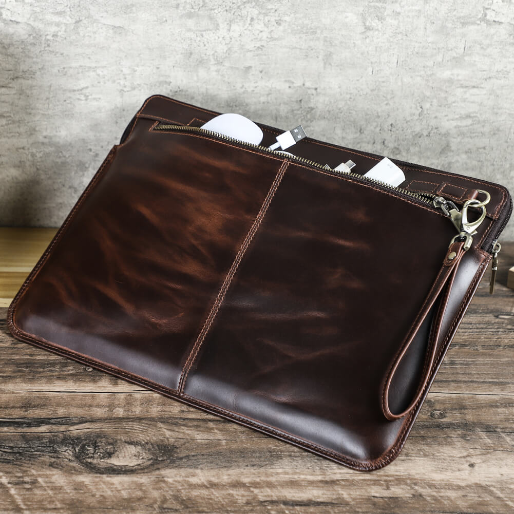 Handcrafted full grain oil bead leather laptop sleeve for MacBook Pro 16-inch with removable wrist strap - It holds a charger and a cable in compartment, exuding a vintage, distrssed, sophisticated vibe.