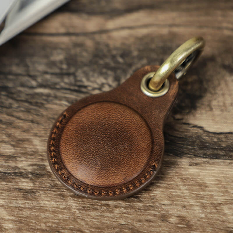 Handcrafted genuine leather AirTag key ring holder case in coffee color back material details close-up