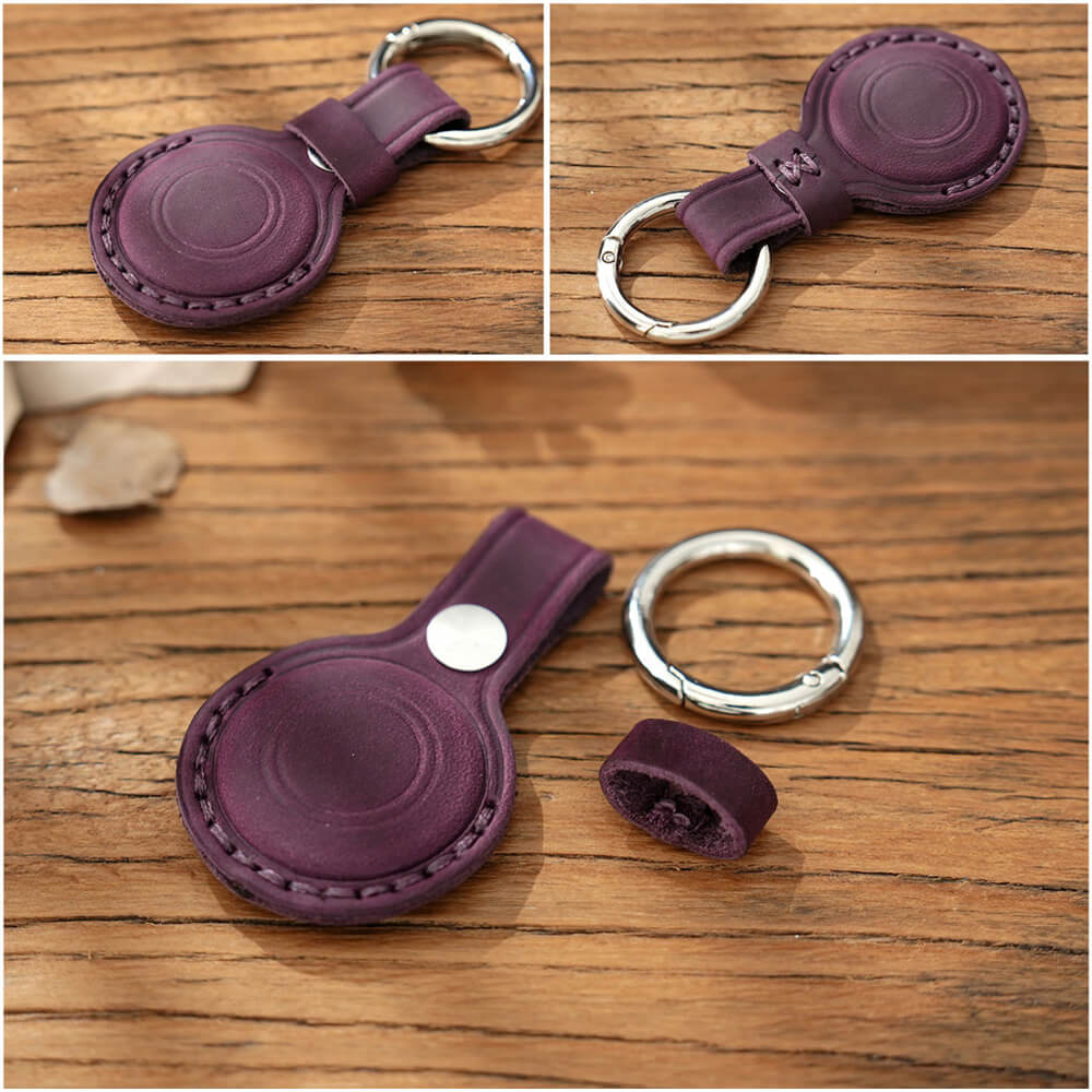 Purple leather keychain with metal ring on a wooden surface