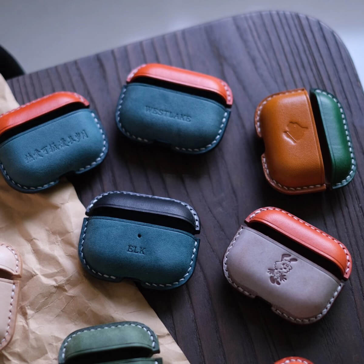 Collection of handcrafted personalized leather earbuds case for AirPods Pro 3th in various colors with six customized text and pattern design - example showcases