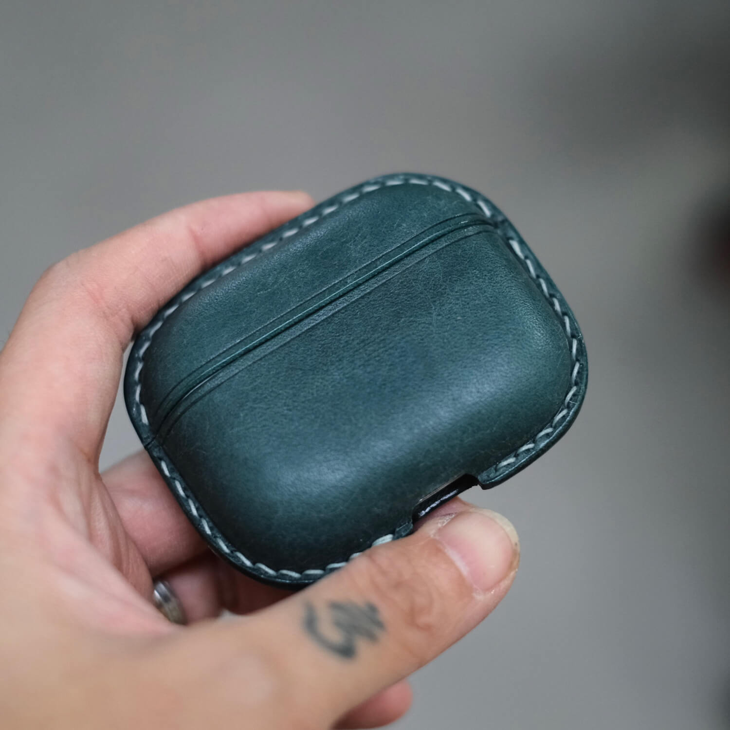 Handcrafted personalized leather earbuds case for AirPods Pro 3 in peacock blue held in hand