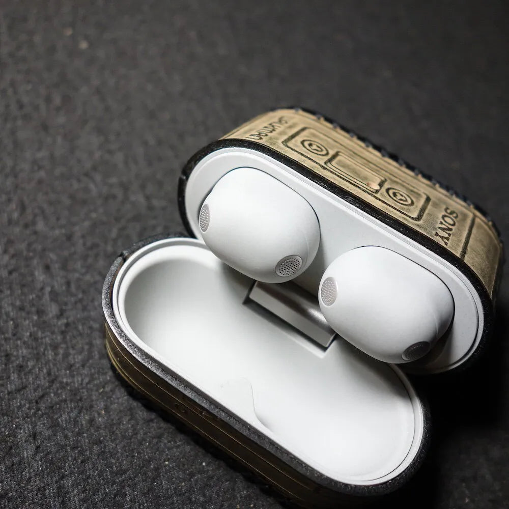 Top-down view of the Sony WF-1000XM6 earbuds in an opened leather case, highlighting easy access and full protection.