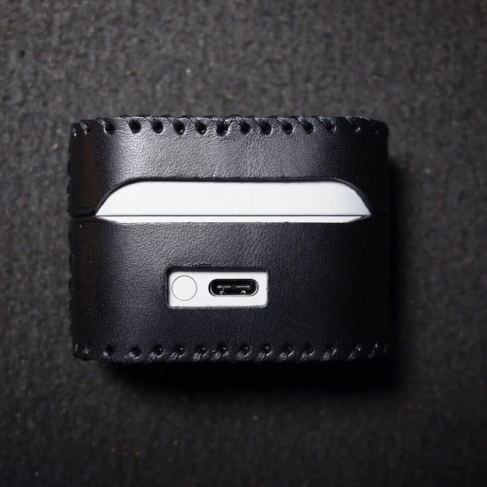 Back view of the Sony WF-1000XM6 black leather case, showing the durable construction and smooth hinge integration.