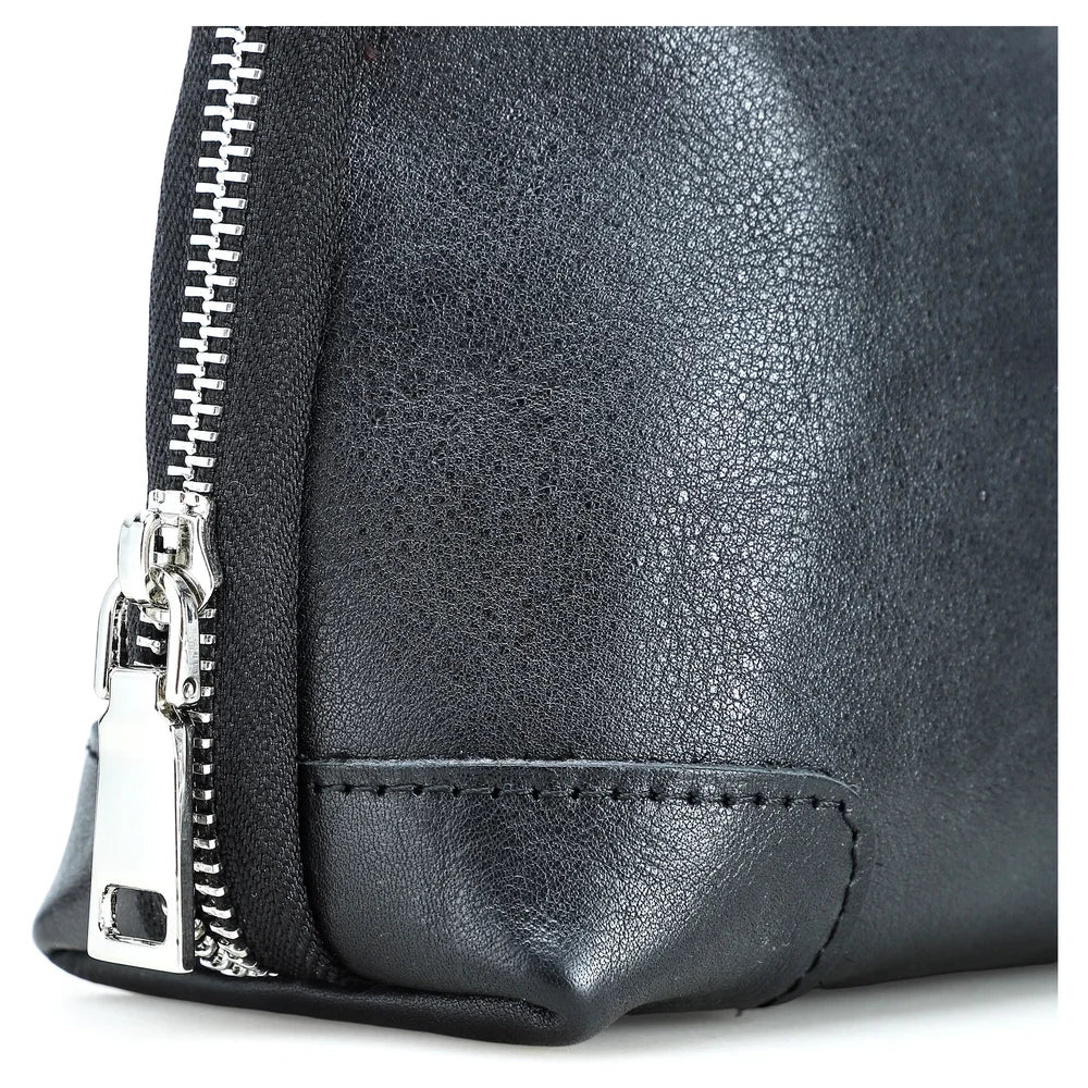 Close-up view of a handmade black vegetable-tanned leather clutch bag, highlighting the silver metal zipper, fine hand-stitching detail, and textured leather finish.