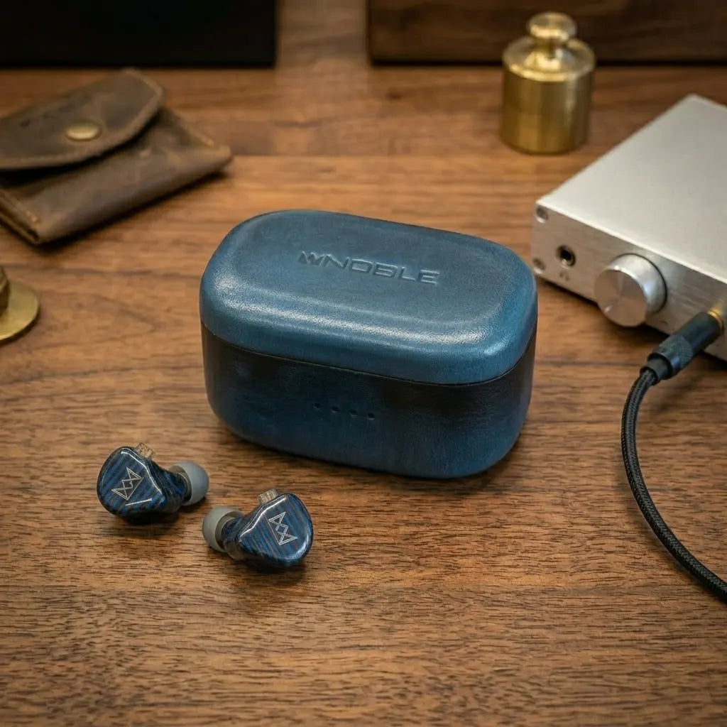 Handcrafted personalized navy blue leather case for Noble Audio FoKus Prestige Encore, featured on a vintage wooden desk with premium accessories