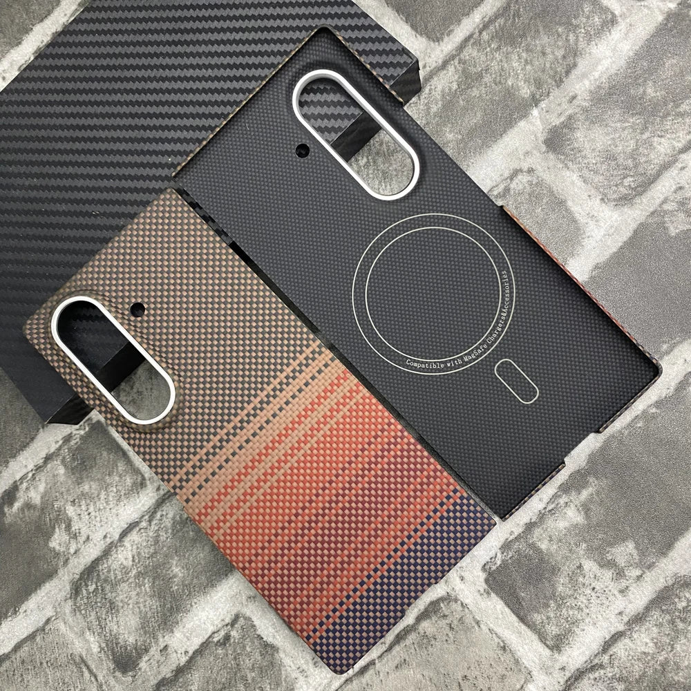 Sunset Red aramid fiber magnetic protective case for Samsung Galaxy Z Fold 8 Ultra. The image shows only the back cover built with a MagSafe-compatible magnetic ring, featuring a red and orange gradient woven Kevlar texture on a brick background. It does not include the hinge protector or front frame.